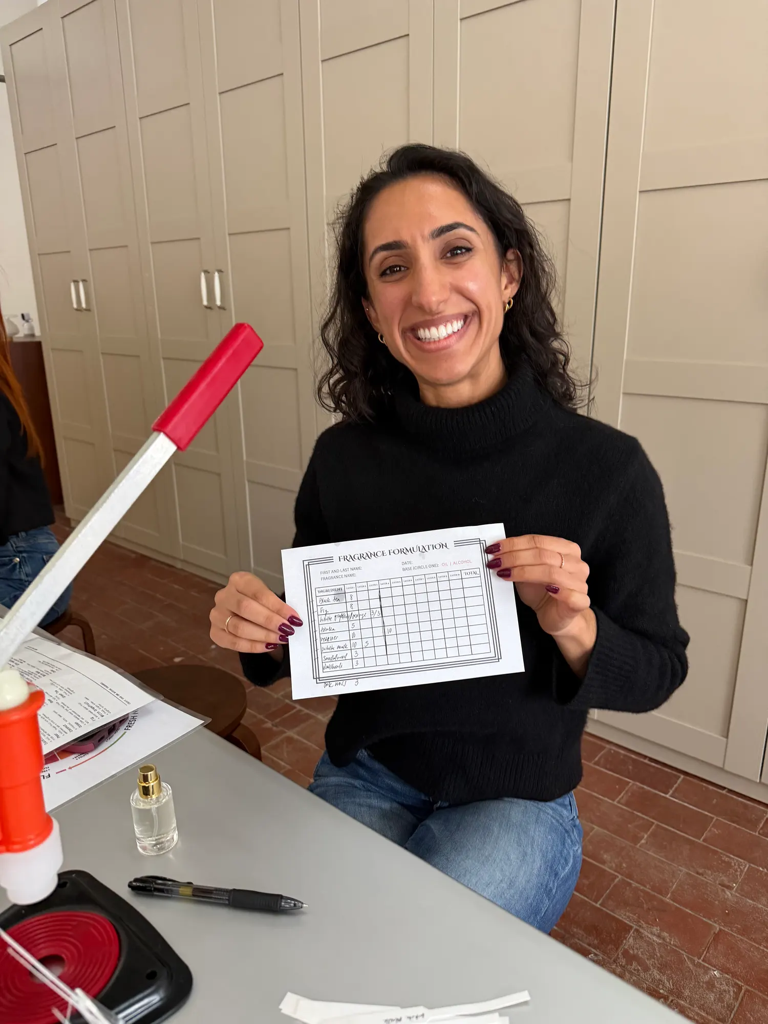 Participant holding her completed fragrance formula card